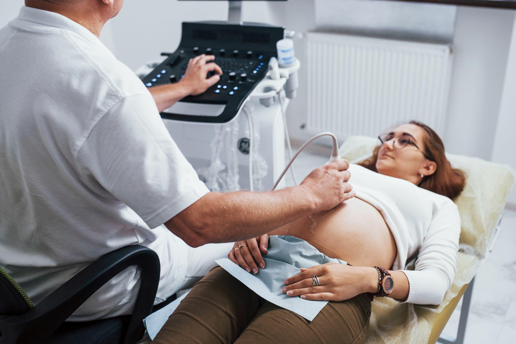 Male Doctor doing Ultrasound for Pregnant Woman
