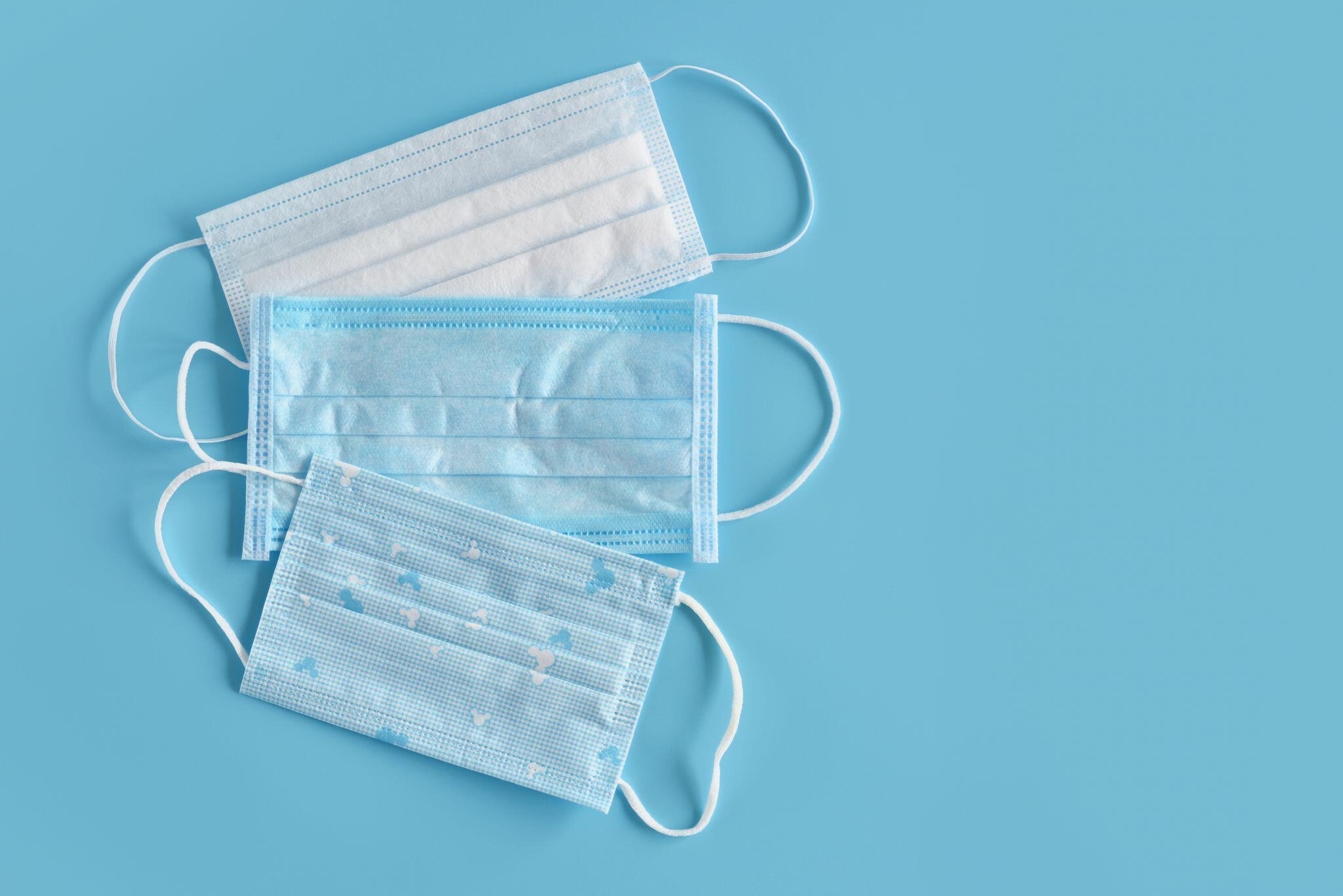 Blue Disposable Medical Masks on Blue Background
