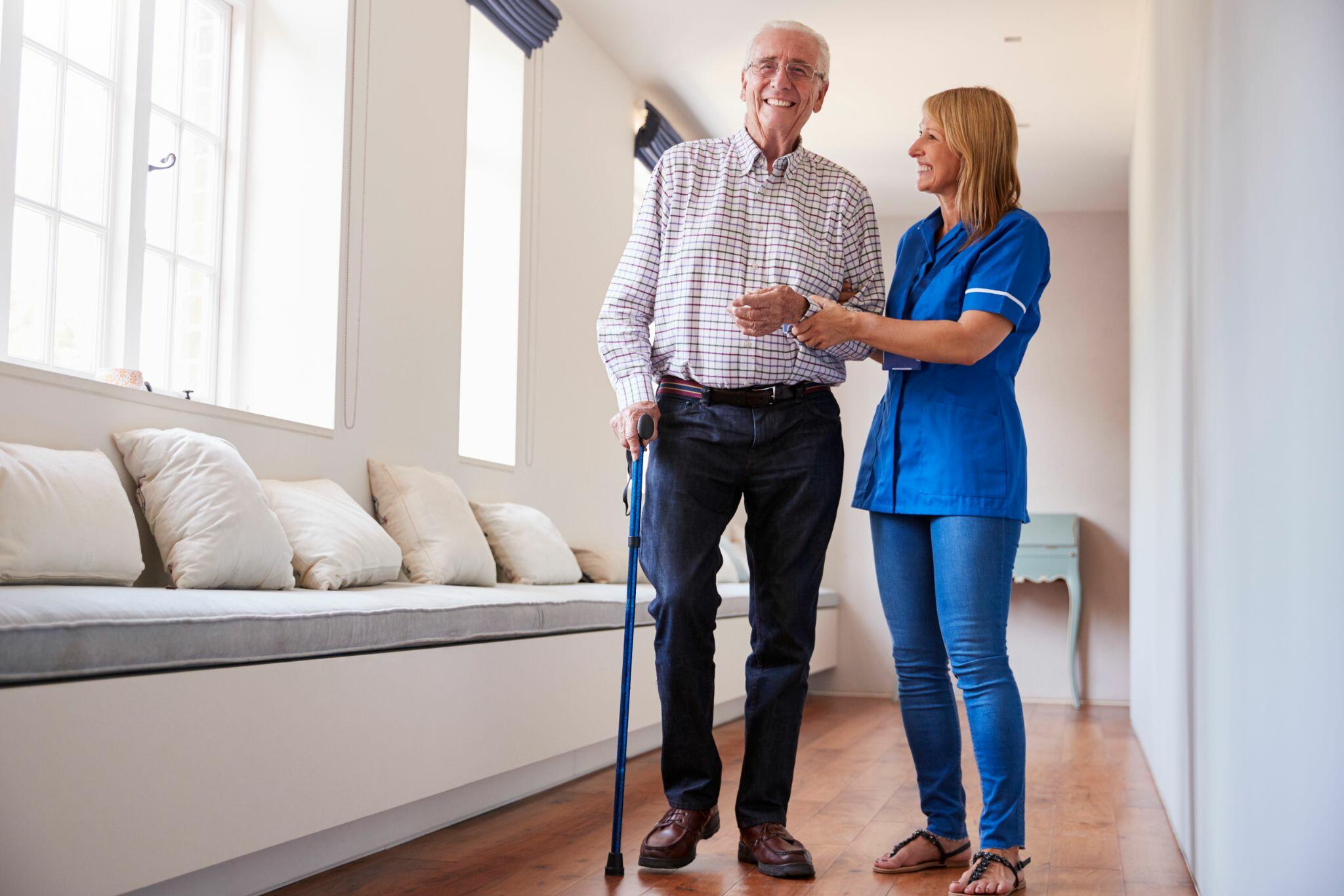 Nurse Helping Senior Man Using Walking Stick 2
