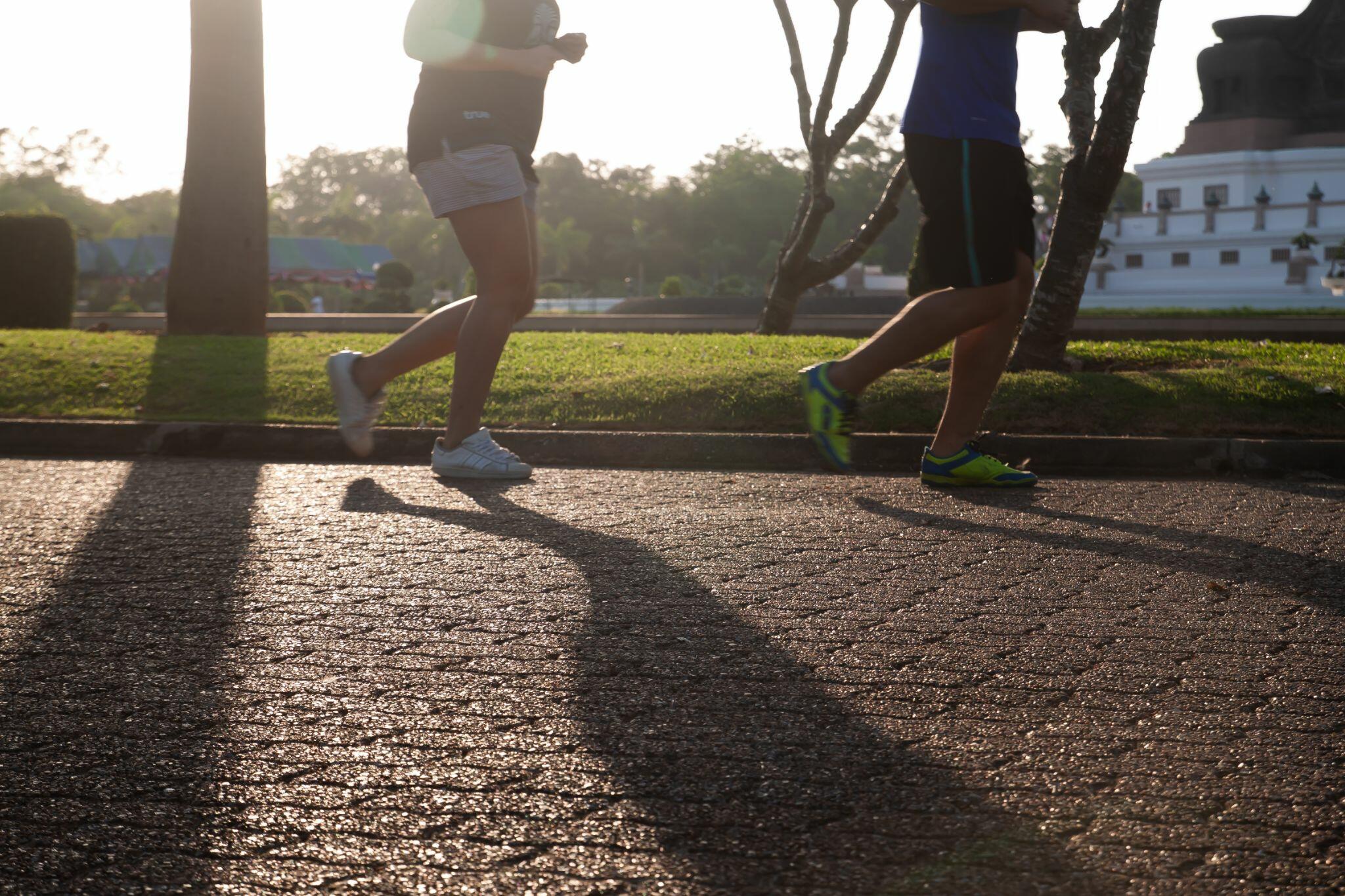 Runners Jogging through Park
