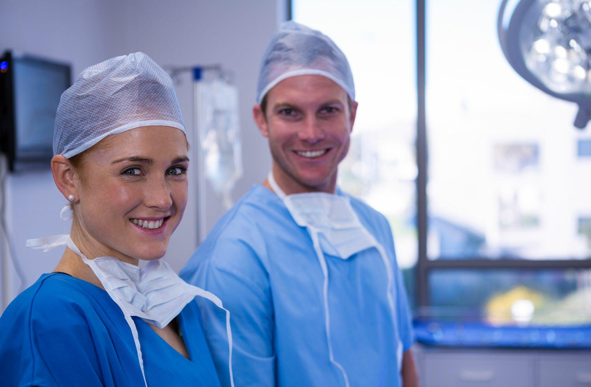Female and Male Nurse Smiling in Operation Room