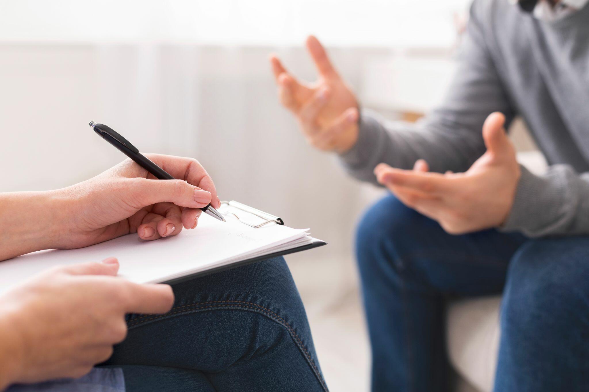 Psychotherapist Writing Notes to Give Diagnosis to Patient