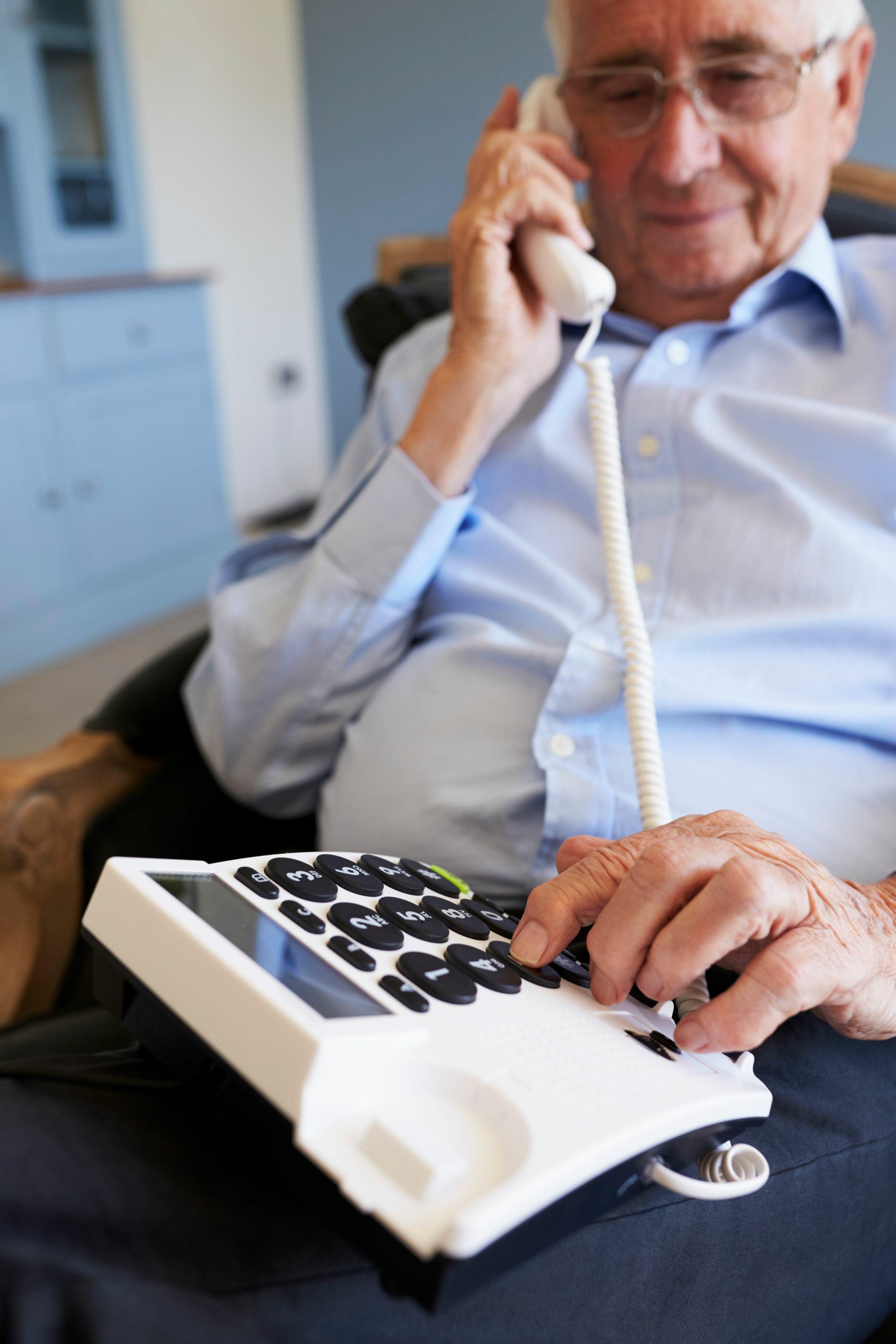 Senior Man at Home Using Telephone