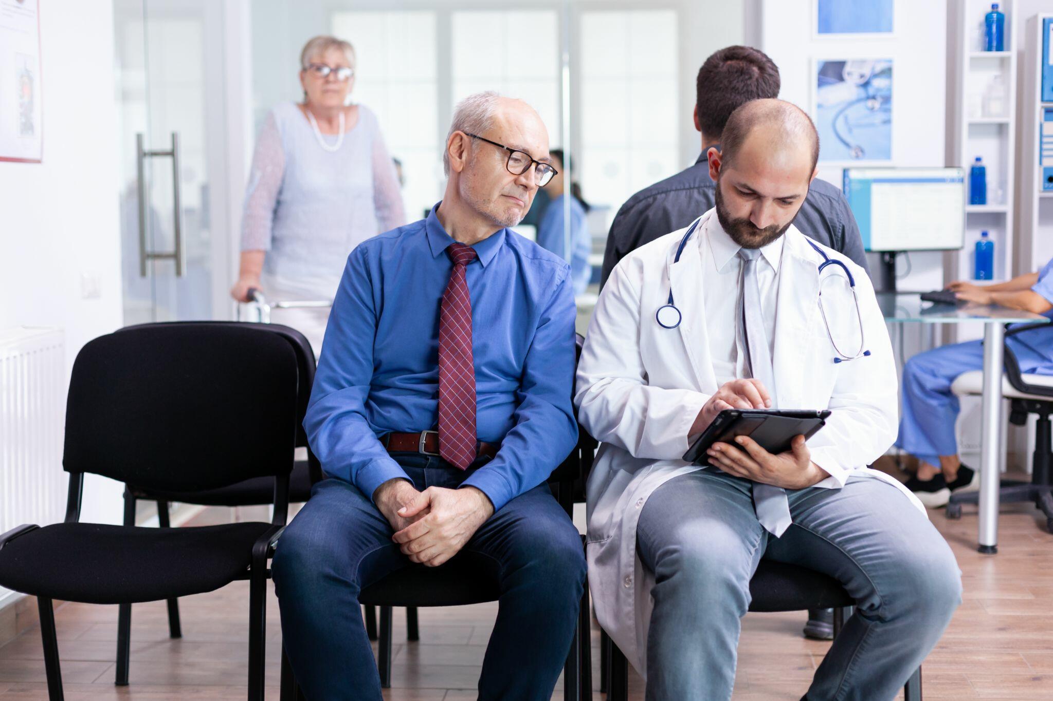 Doctor Giving Senior Man Diagnosis while Sitting