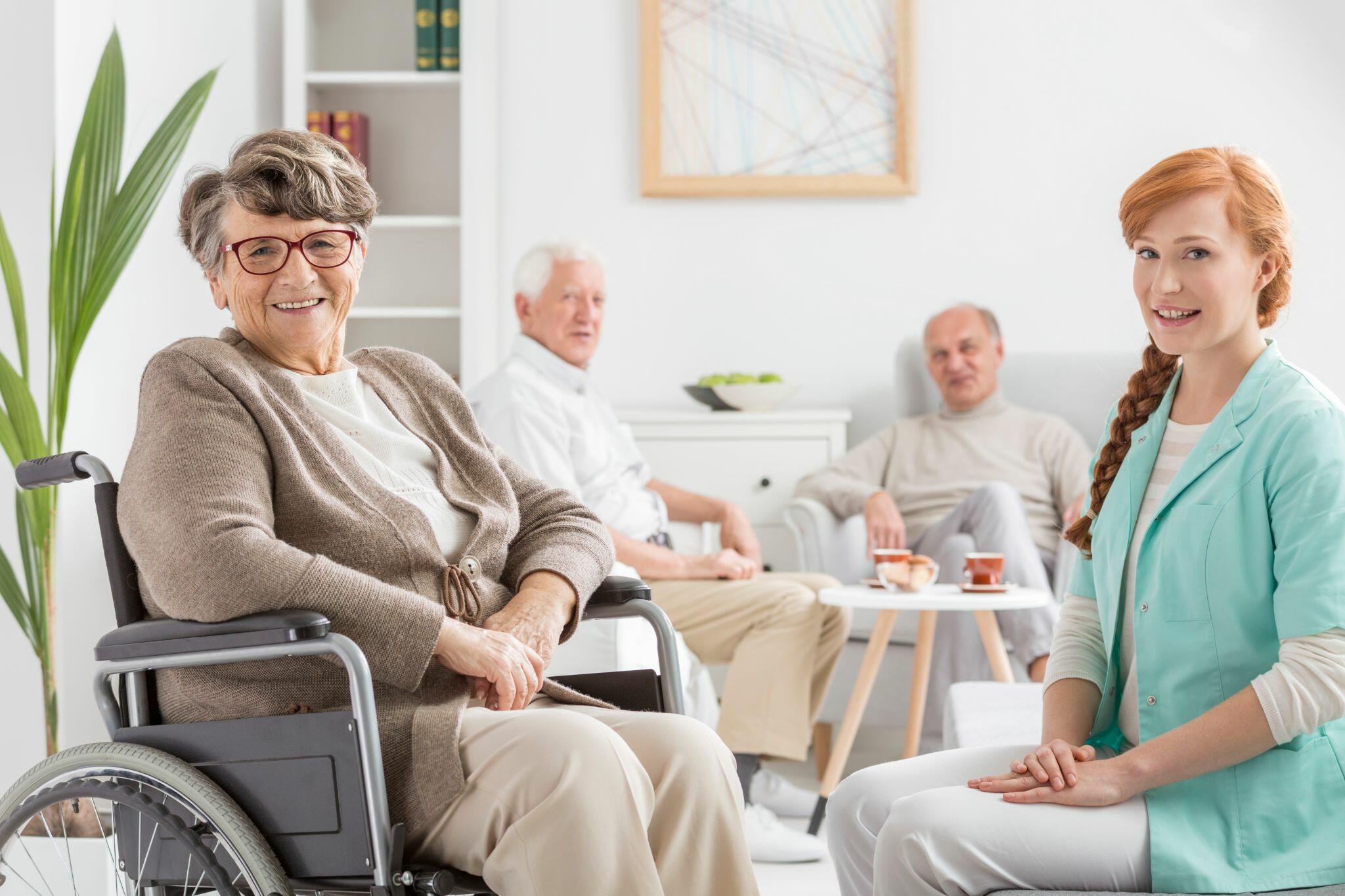 Seniors and Nurse Smiling while Sitting Down