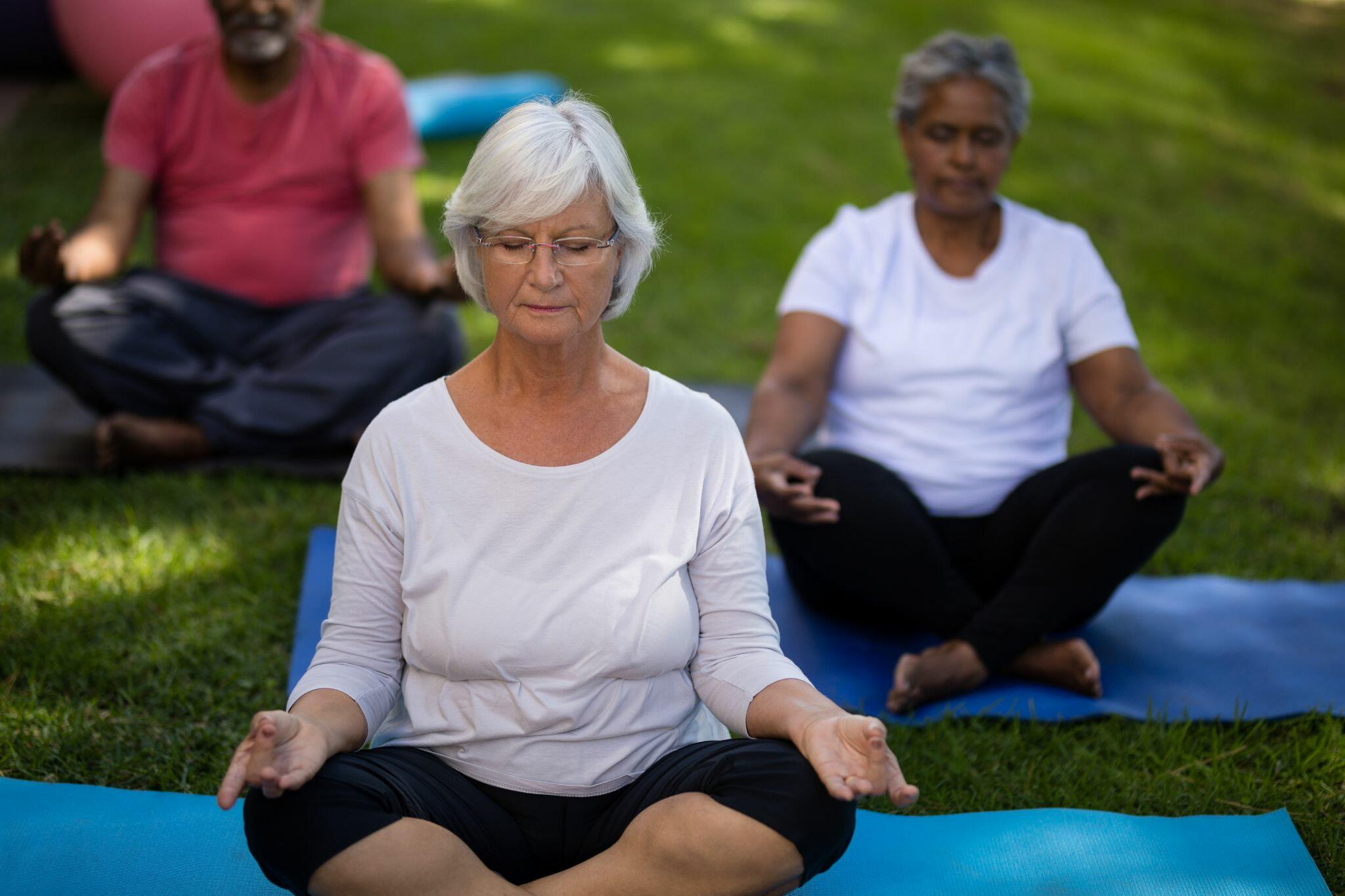 Senior Women Meditating at a Park