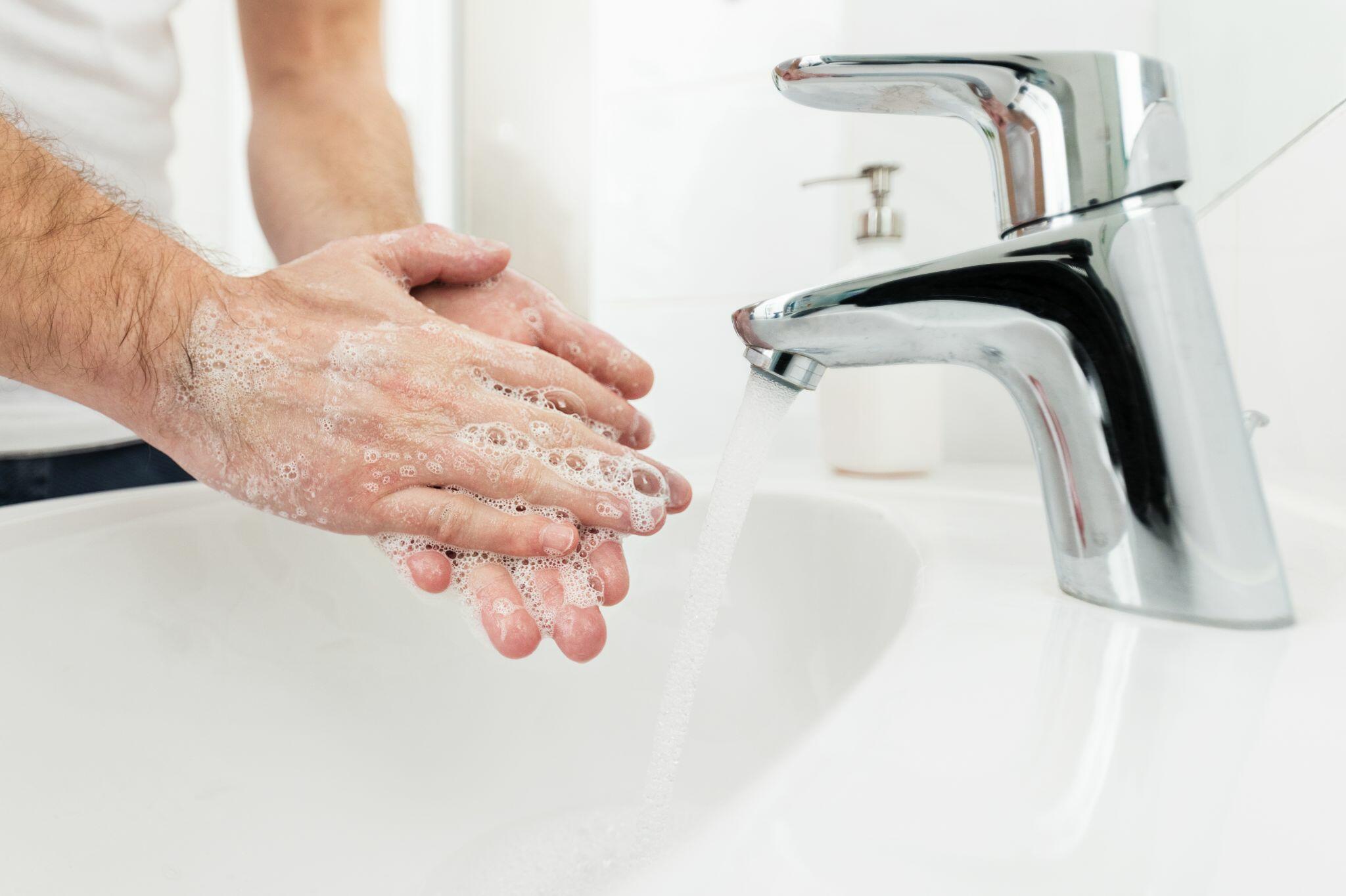 Senior Man Washing Hands at Home