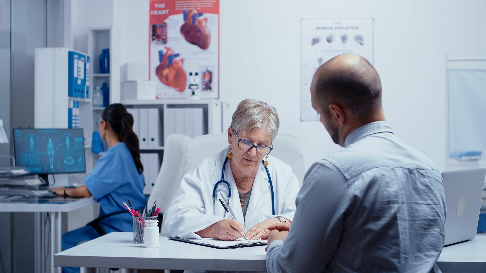Doctor Writing a Prescription to Patient